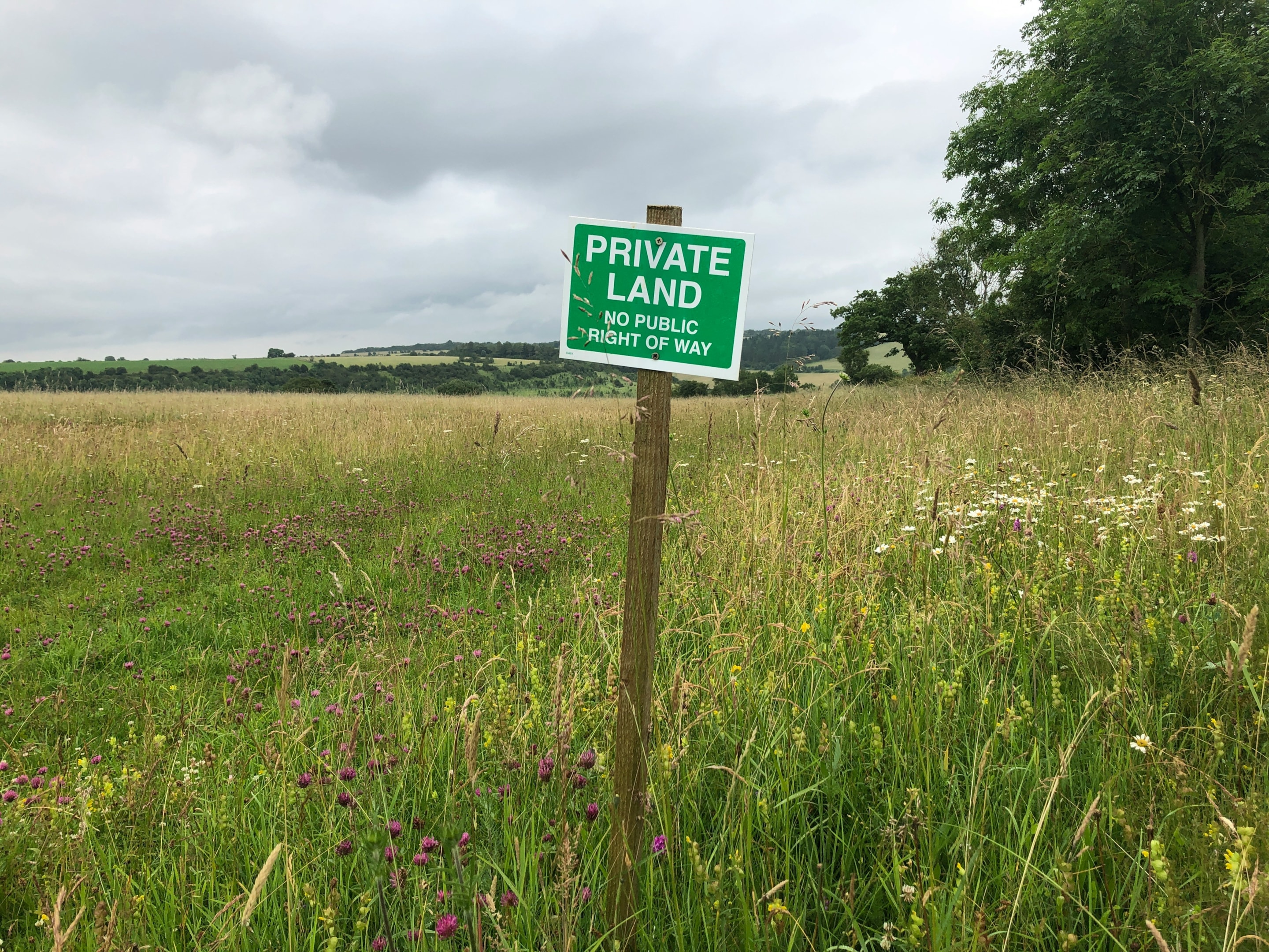'Private Land' sign posted on property that was recently purchased by a real estate investor.