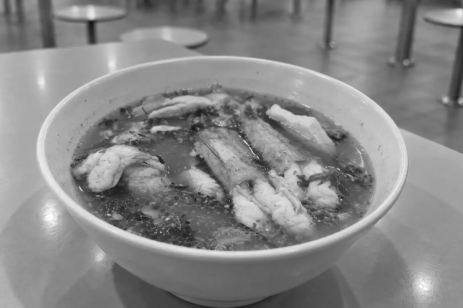 A bowl of Fish and Prawn Soup with generous pieces of fish and prawns served in a clear, flavorful broth.