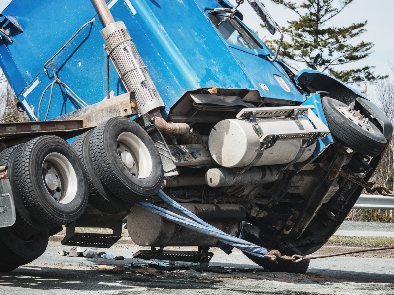 An image showing an 18 wheeler on its side to identify liability in Gwinnett County.