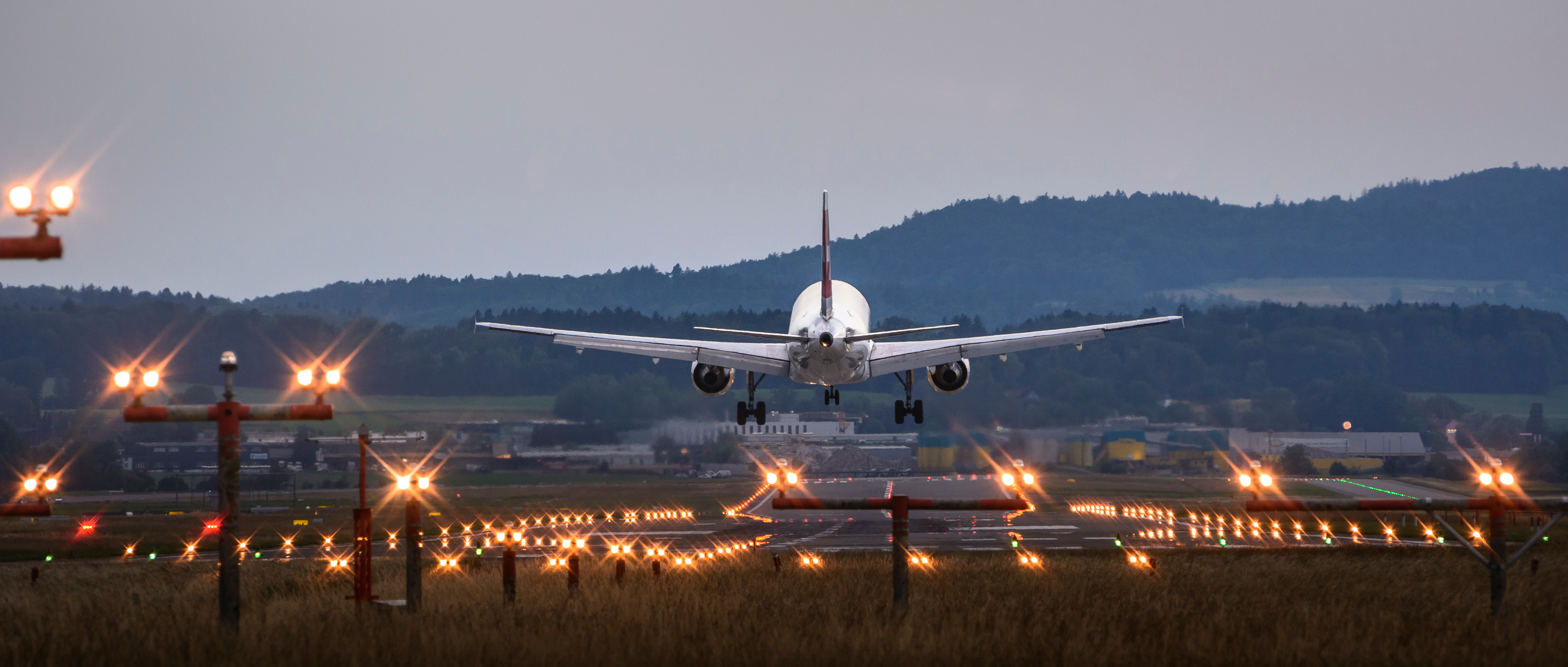 An aircraft approaching a runway for landing.
