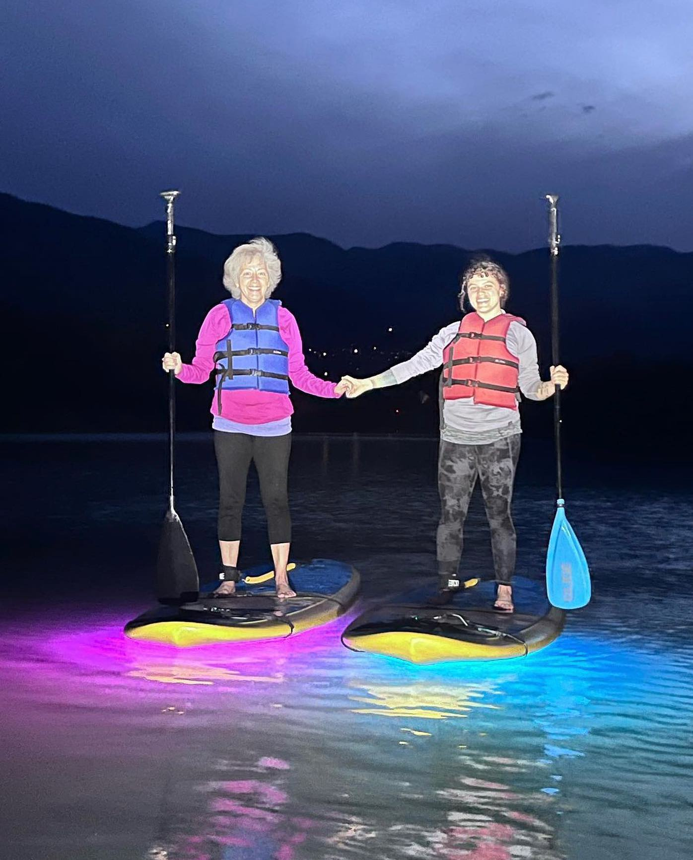 two women on stand up paddle boards