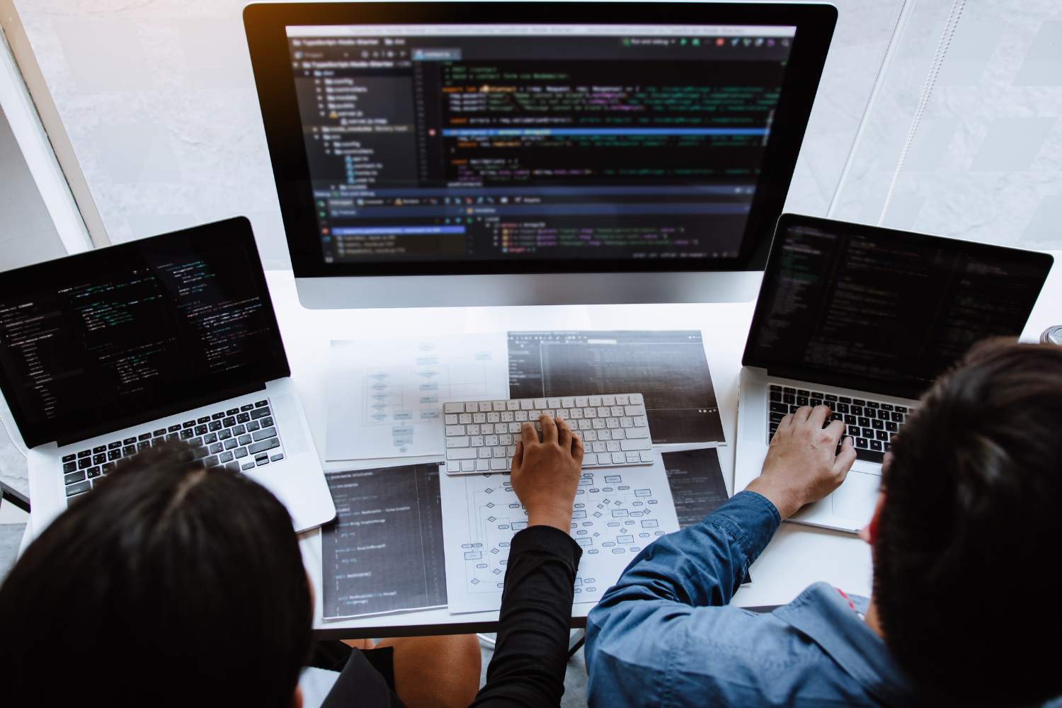 Filipino professionals designing, coding, and writing in a professional office setting.