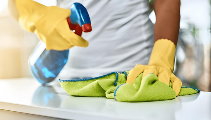 A surface is being cleaned with microfiber towel using chemical in minute amount
