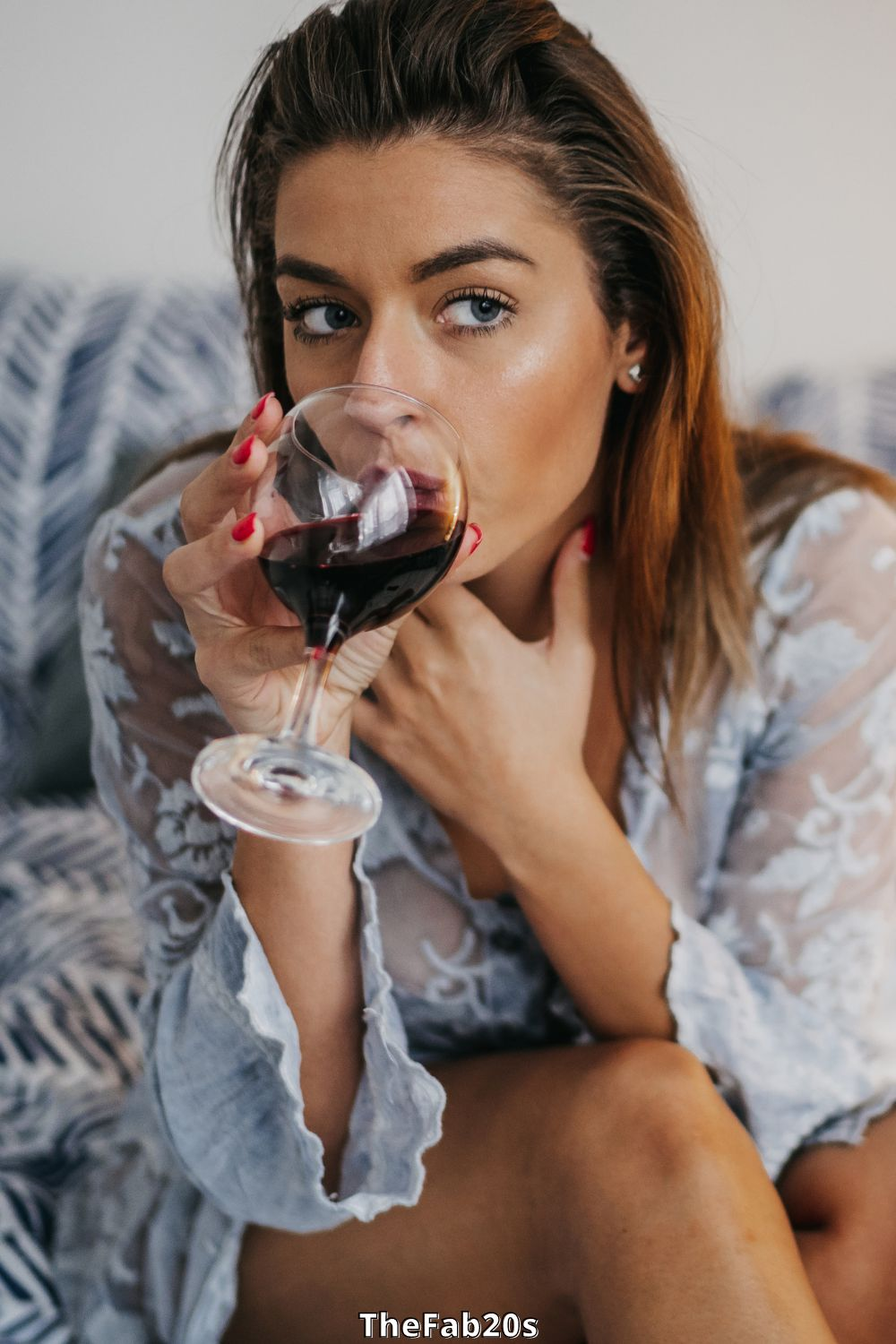 Woman drinking glass of wine - what are the signs your ex wants you back?