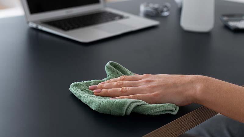 Using a Microfiber towel to clean a table