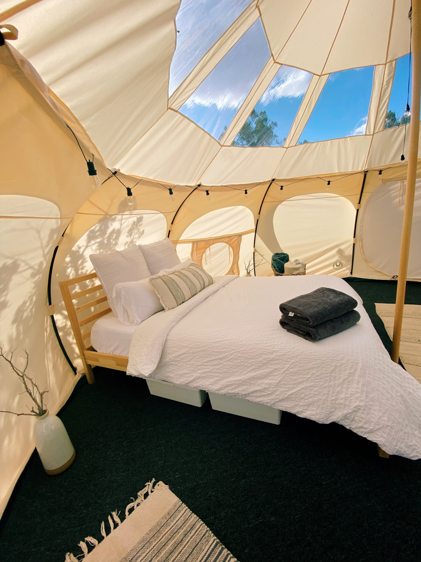A modern yurt with wooden poles and an outer layer of felt