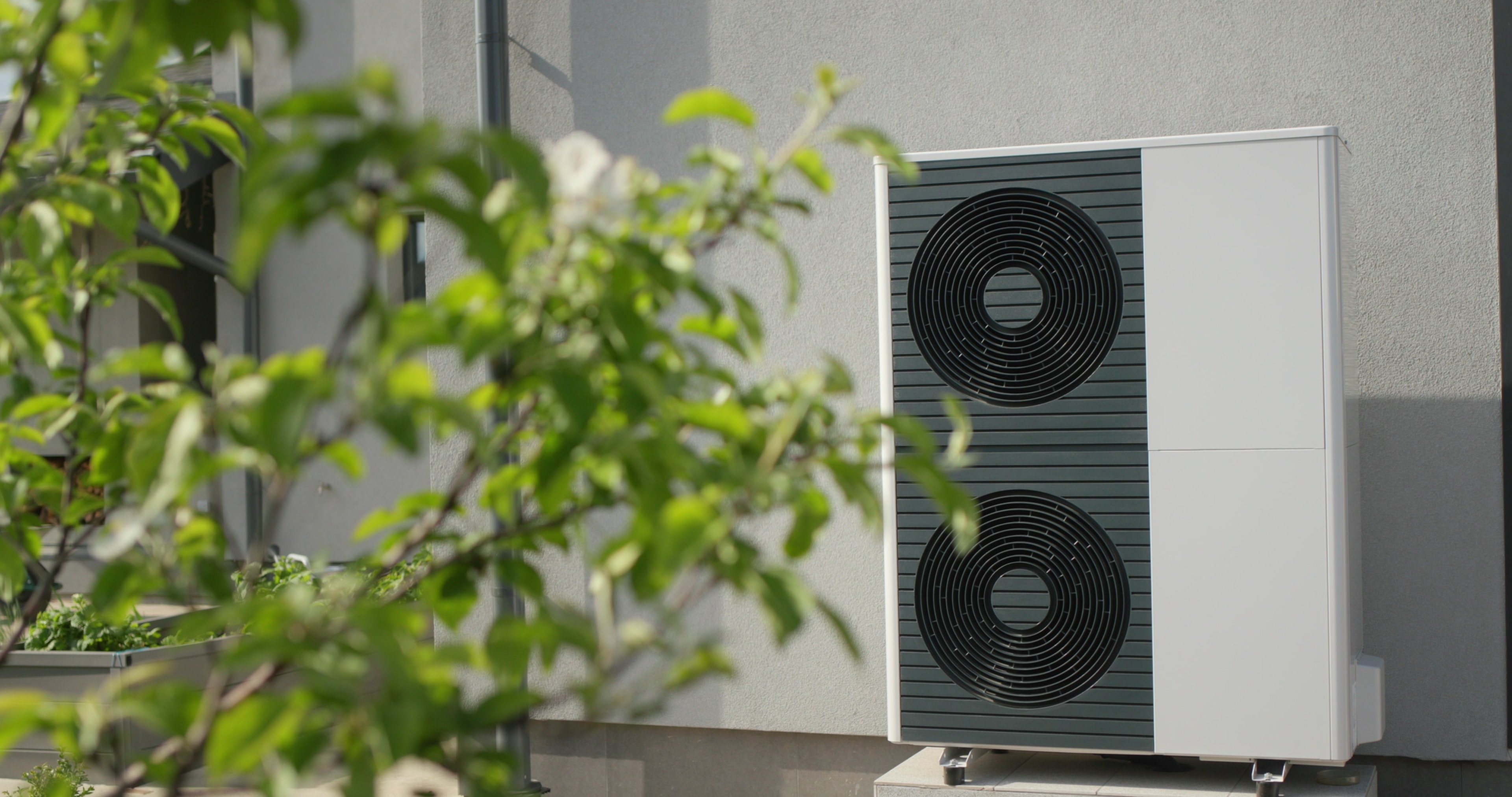 A soundproofing solution being applied to a heat pump to reduce noise levels.