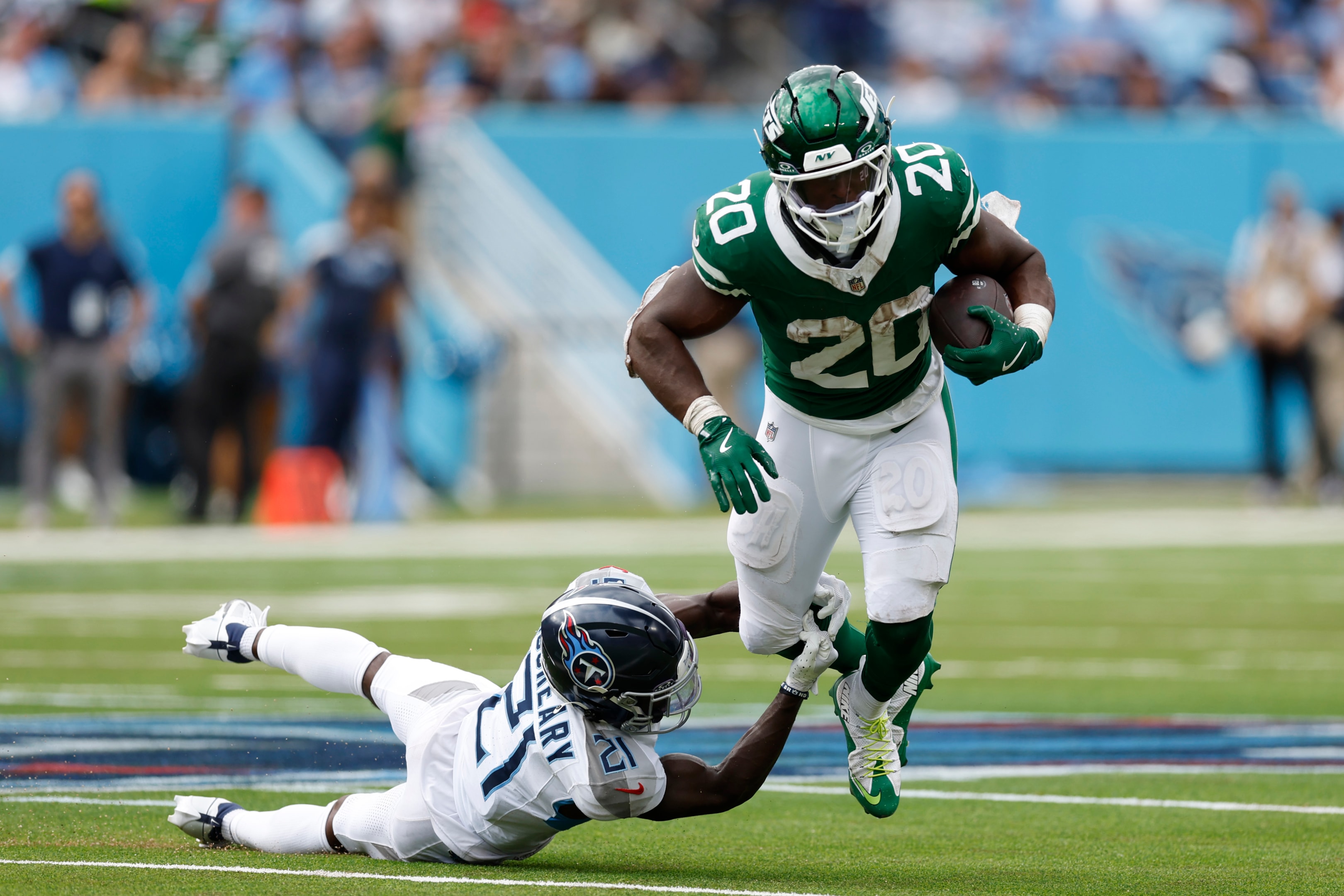 Breece Hall of the New York Jets is tackled during the fourth quarter at Nissan Stadium on September 15, 2024 in Nashville, Tennessee.