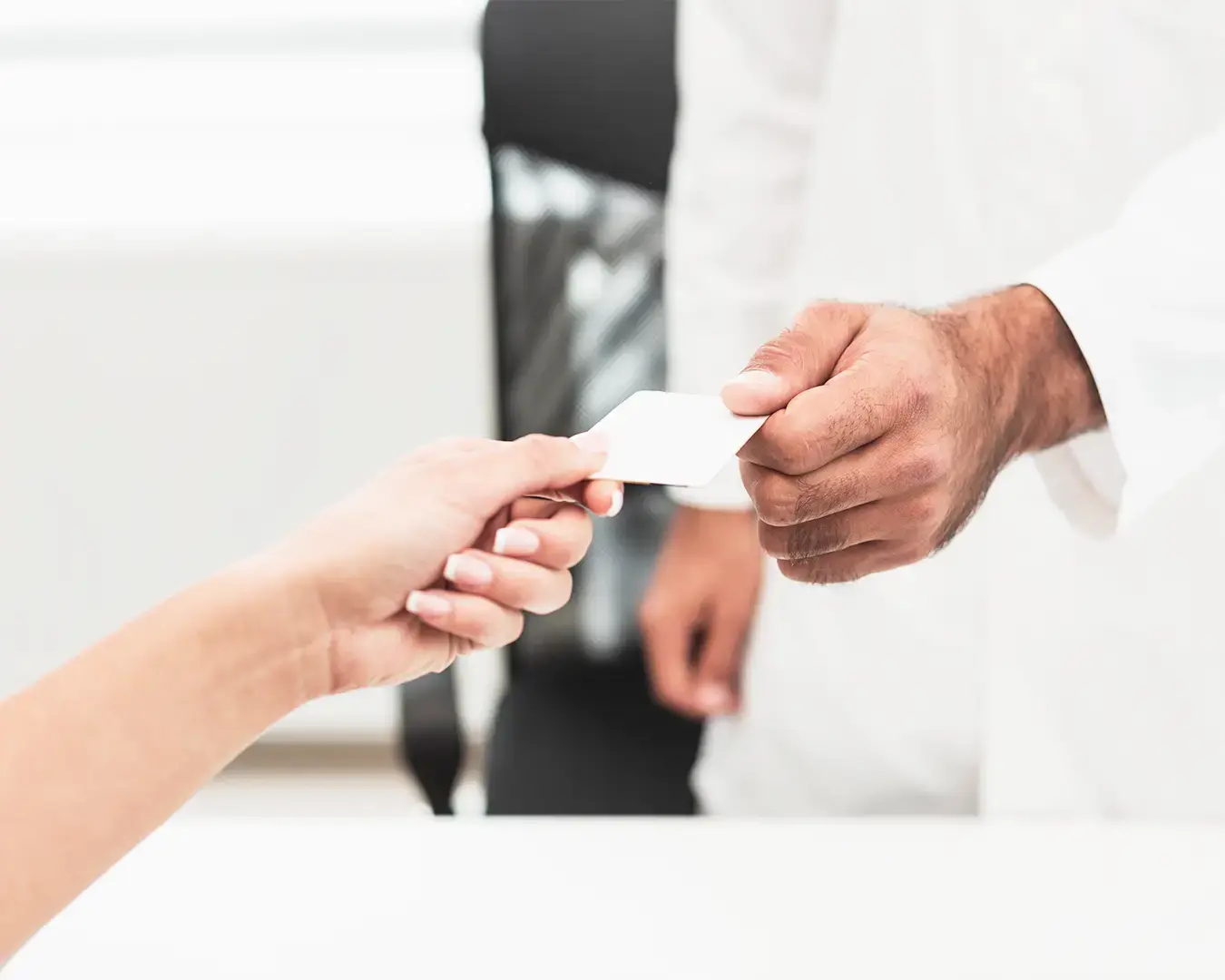 Restaurant customer receiving loyalty card from staff for repeat dining rewards