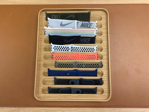 An image of a person wearing an Apple Watch with a band of different colors and materials
