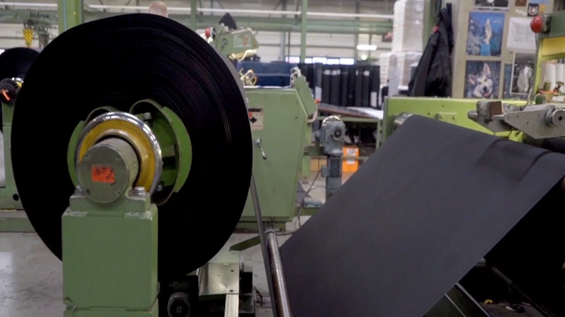 EPDM production process showing rubber sheet rolling on an industrial machine