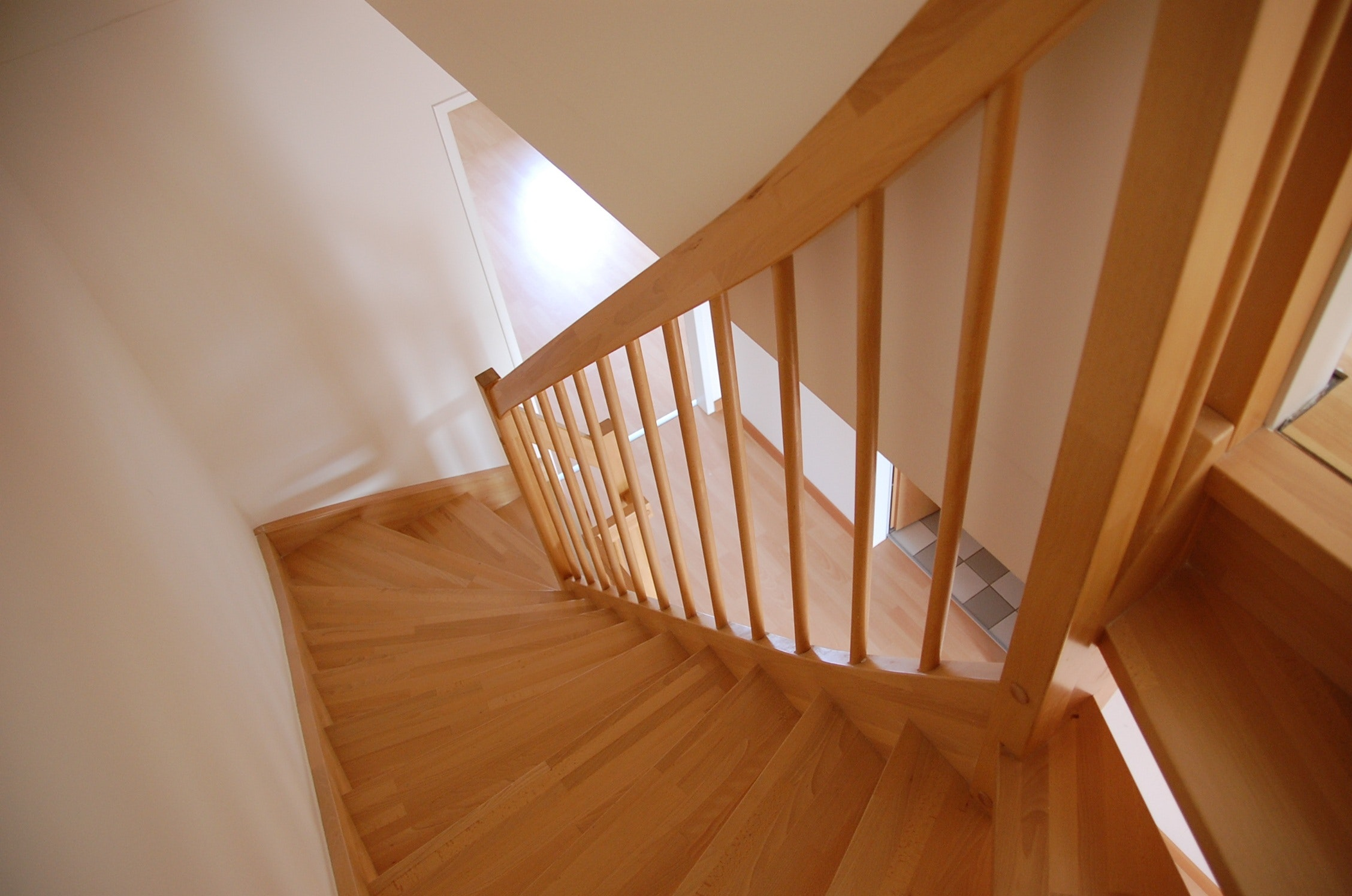 A person installing laminate planks on a staircase
