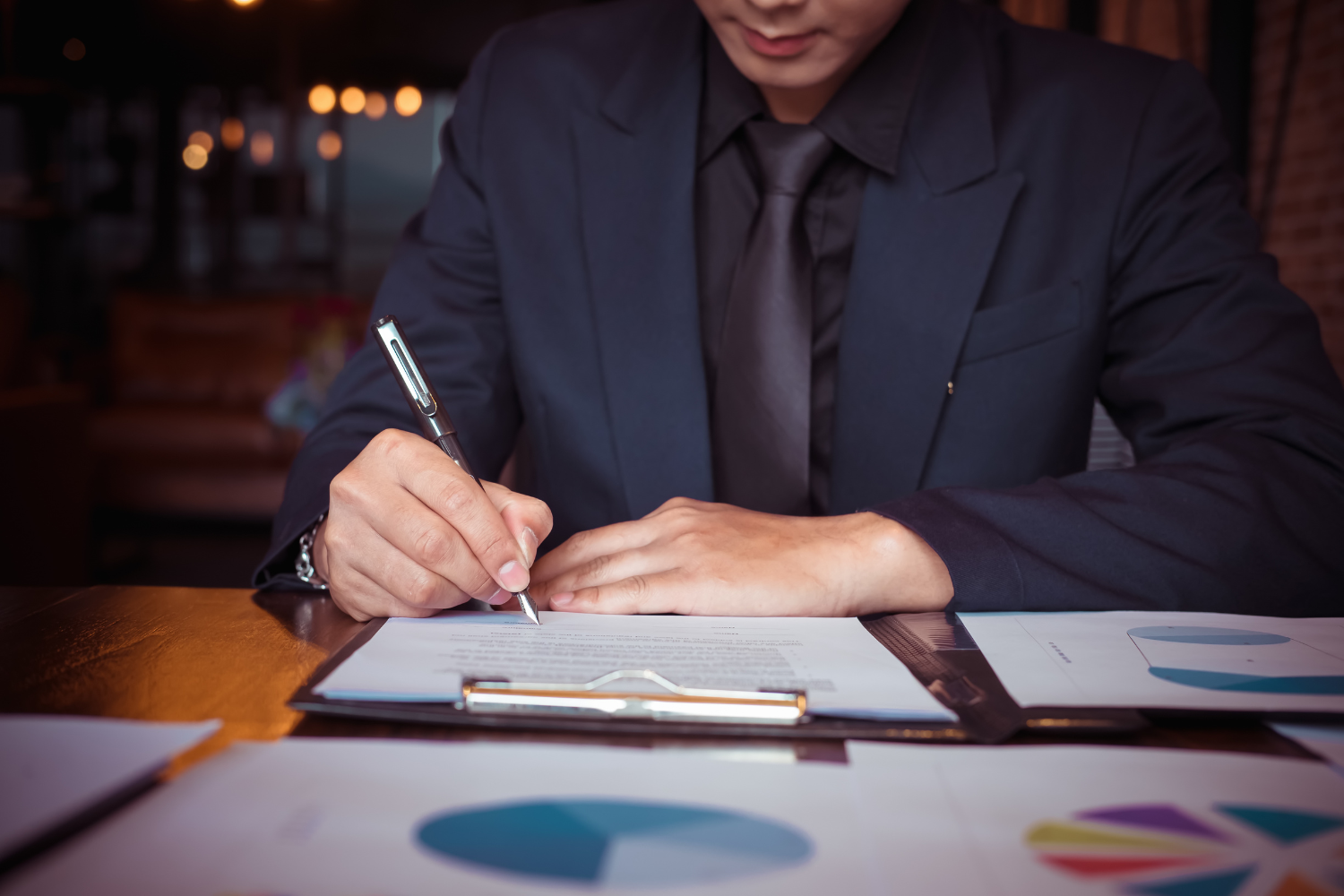 Businessperson writing on a clipboard.
