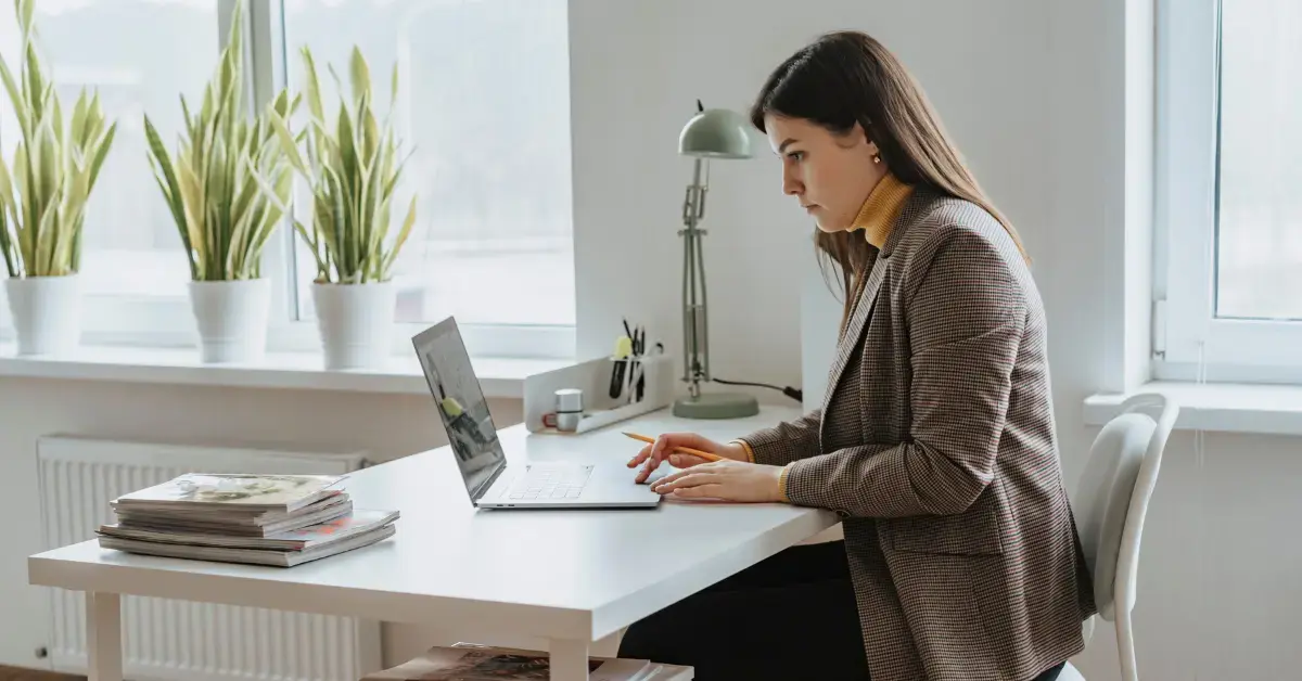 A woman reviewing an audit reconsideration notice with bank statements and income records.