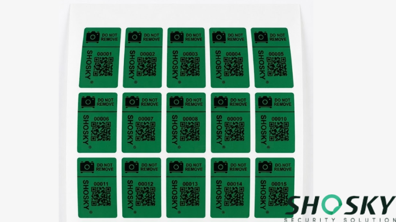 A grid of serialized green anti-tamper stickers for camera privacy