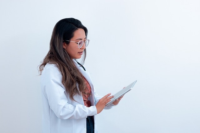 Female Doctor Looking at Patient's Chart