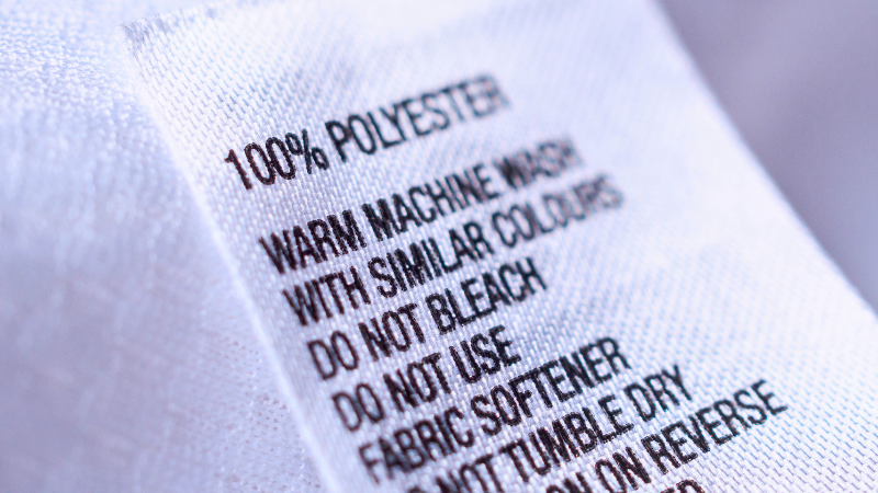 A close up of a label on a white polyester shirt