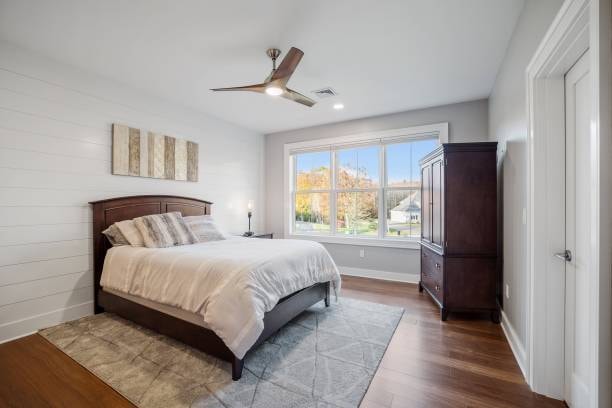 A ceiling fan in a rectangular room. 