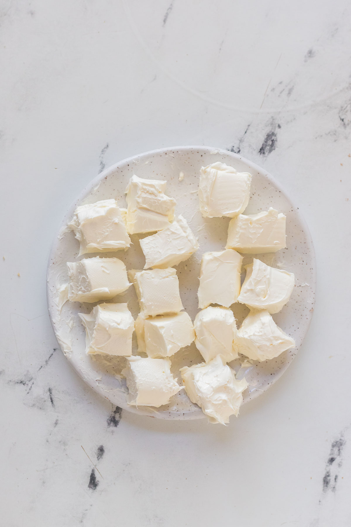 cream cheese cut into cubes on a plate