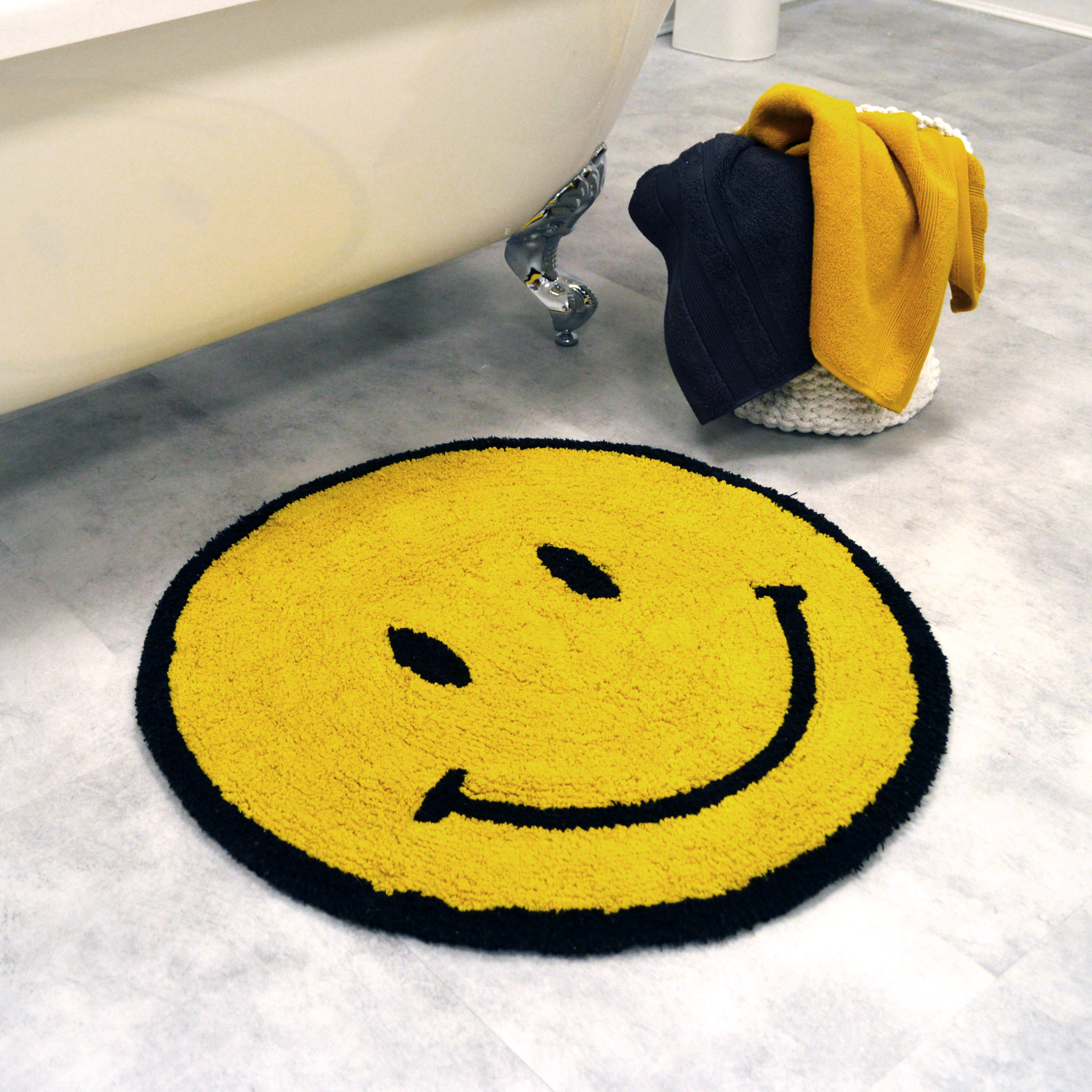 yellow bath mat with a smile