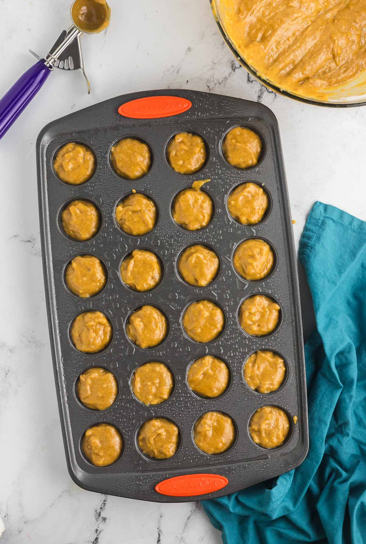 unbaked mini pumpkin muffins in a mini muffin pan