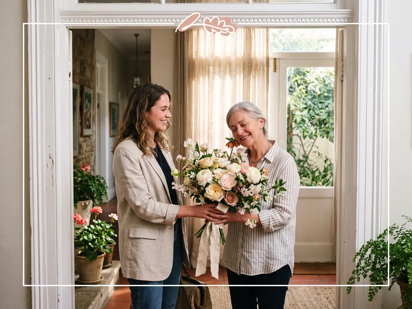 Daughter giving her mom a hand-tied birthday bouquet of garden roses and sweet peas at the door from Fabulous Flowers Cape Town