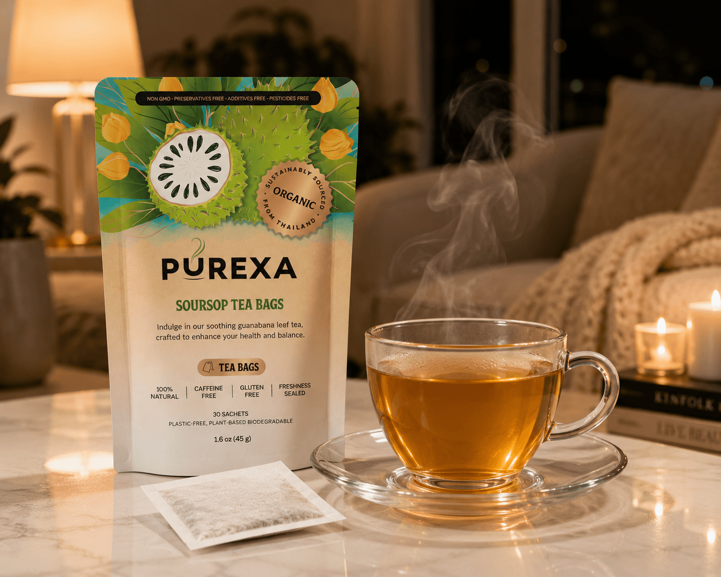 A cozy evening relaxation setting featuring a pouch of PUREXA soursop tea bags standing behind a steaming glass cup of amber-golden herbal tea, resting on a marble tabletop with lit candles in the background.