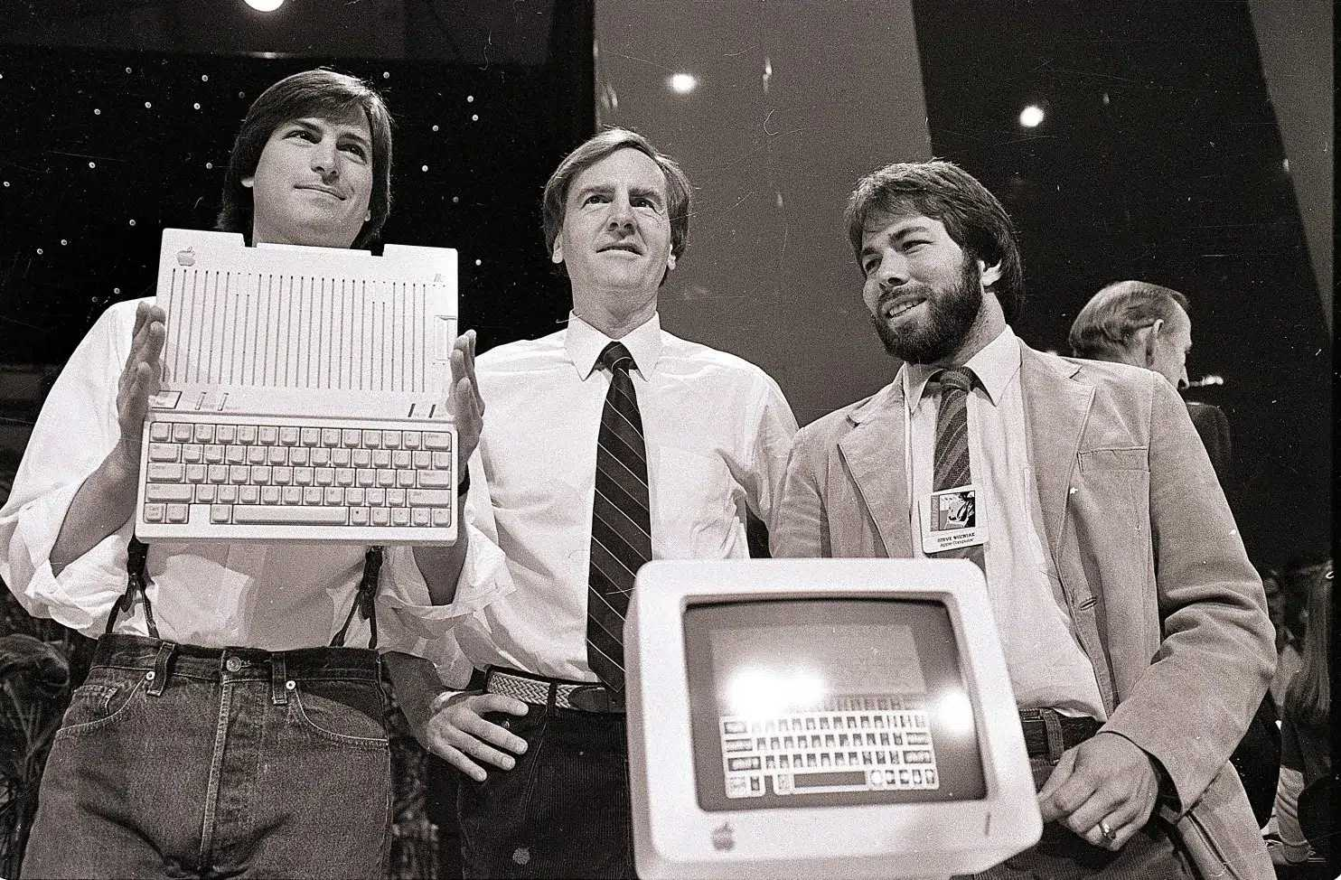 Steve Jobs, left, chairman of Apple Computers, John Sculley, centre, president and CEO, and Steve Wozniak, co-founder of Apple, unveil the new Apple IIc computer in San Francisco, April 24, 1984. (SAL VEDER/ASSOCIATED PRESS)