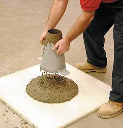 Illustration of a slump cone with fresh concrete being measured for workability and consistency