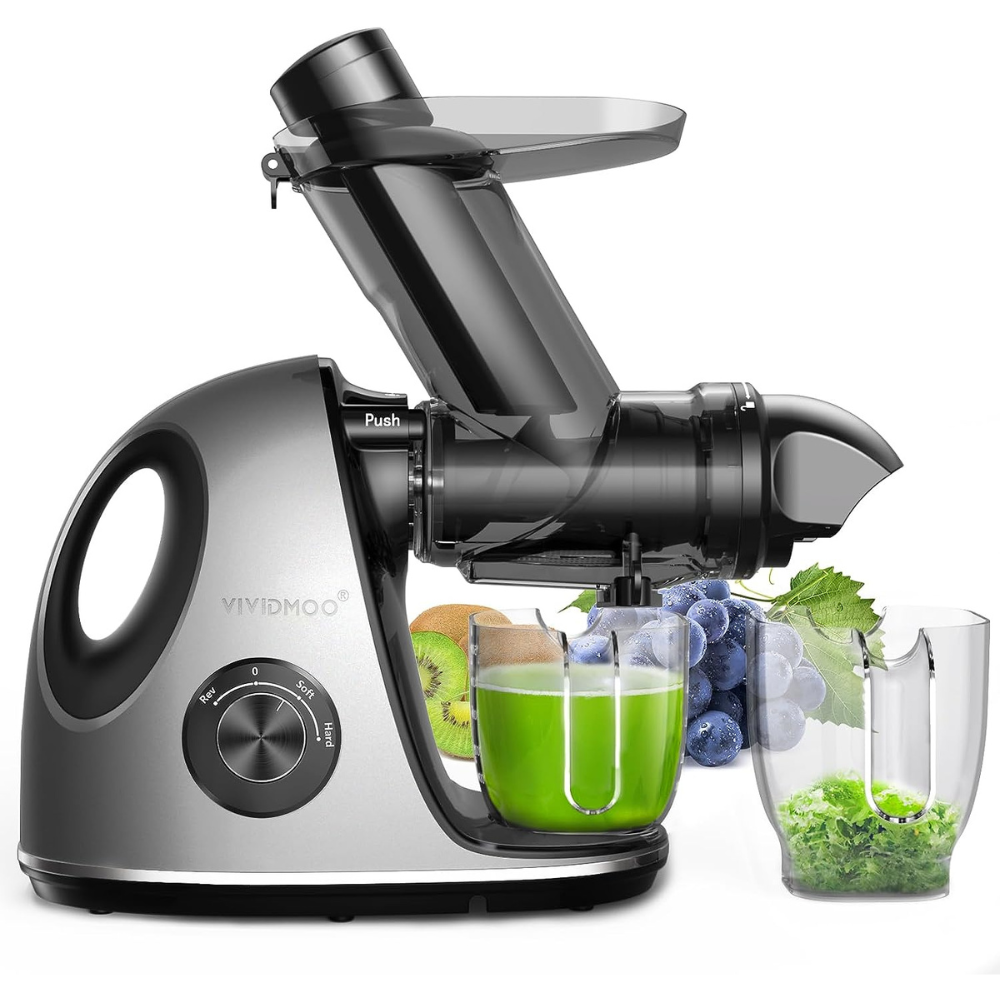 A masticating juicer with fruits and vegetables in the background, extracting celery juice from celery and other leafy green vegetables
