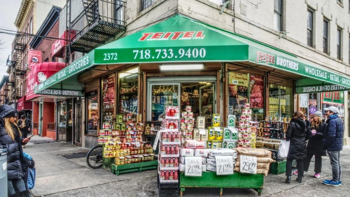 Teitel Brothers where you can get olive oil, hot sauce, dried pasta, fresh ricotta, salt packed anchovies, own mozzarella, Calabria Pork Store showcasing meat hanging and on display