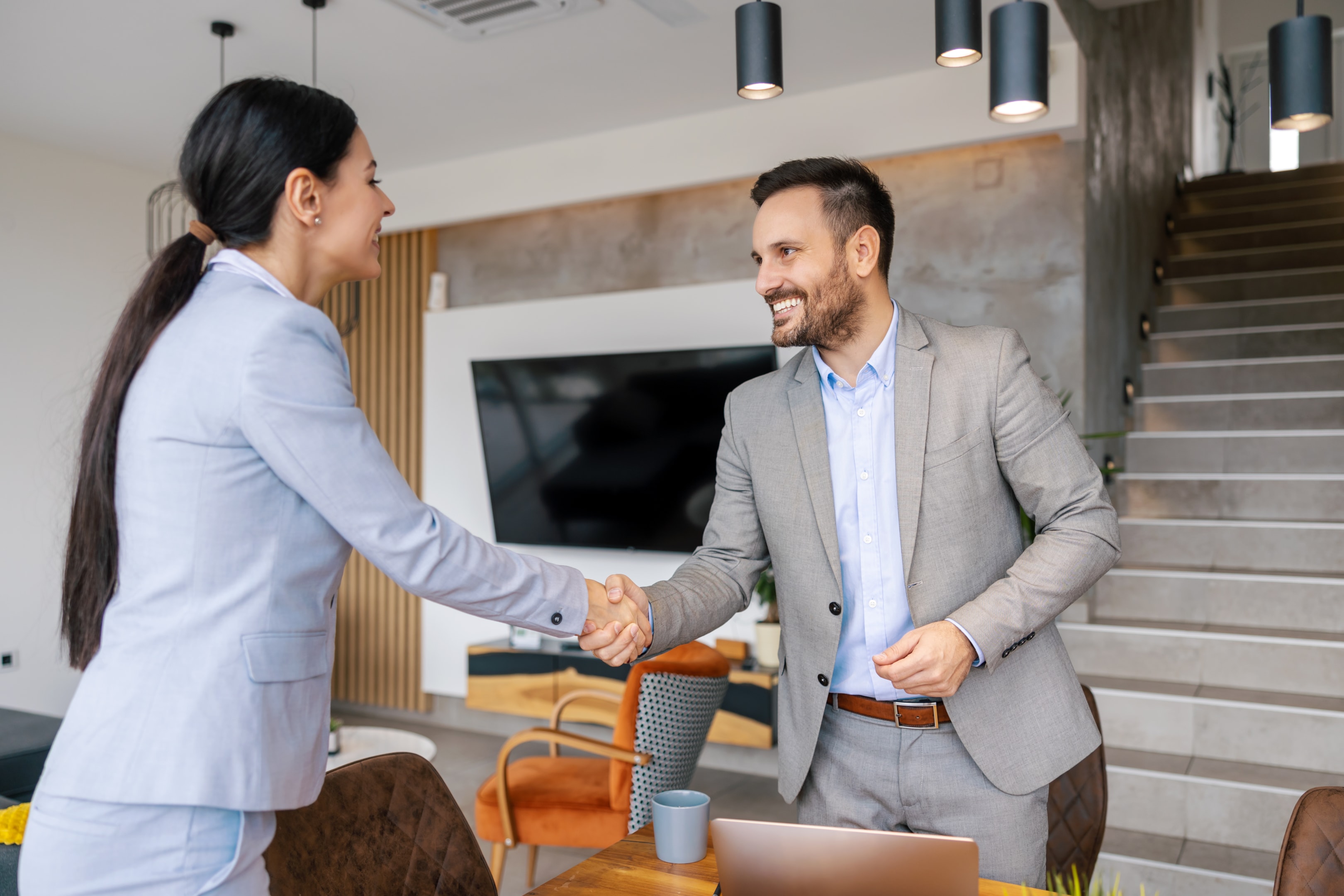 two businesspeople sharing hands agreeing to be event sponsors