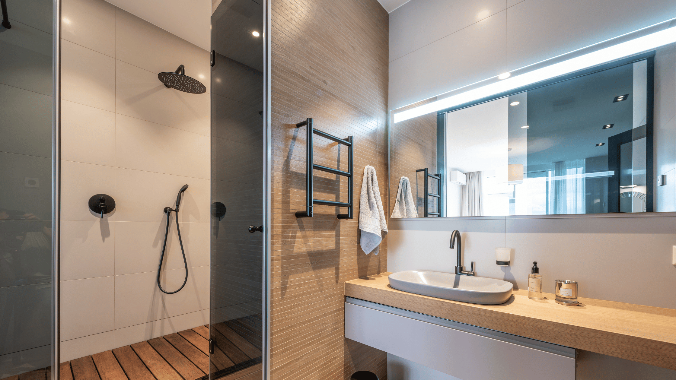Clean, minimalist bathroom in OH luxury apartments, featuring community amenities like a floating vanity and smart lighting—products available in both metric and imperial units for global compatibility.