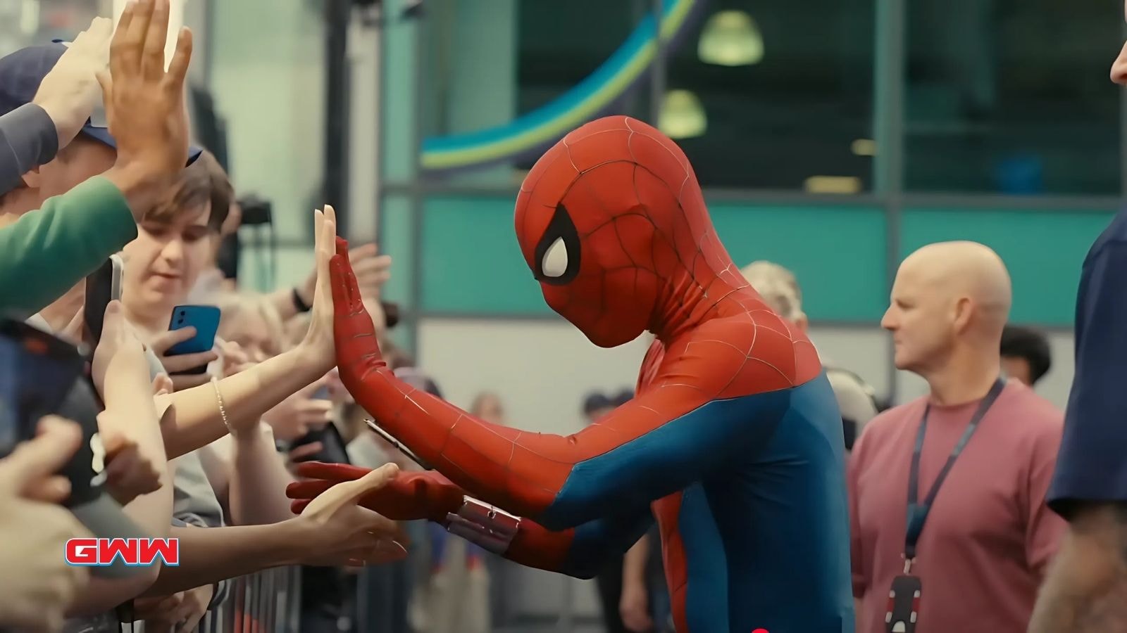 Tom Holland as Spiderman high fiving fans in Spider-Man: Brand New Day