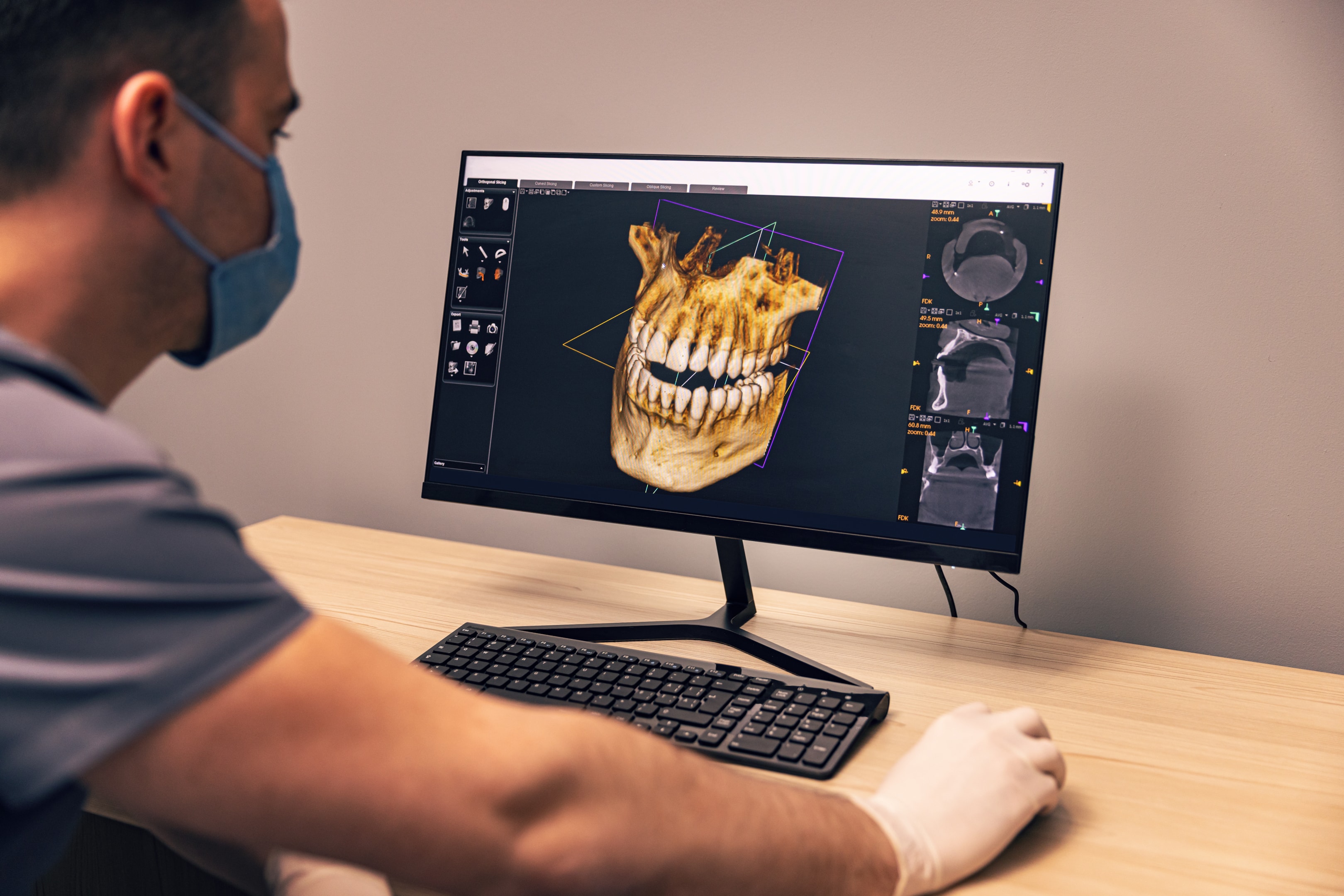 an oral surgeon doing comprehensive research into a patient's history and scans to determine the best future course of treatment for their unique needs