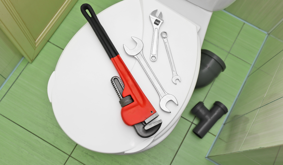 Closed toilet seat with tools placed on top