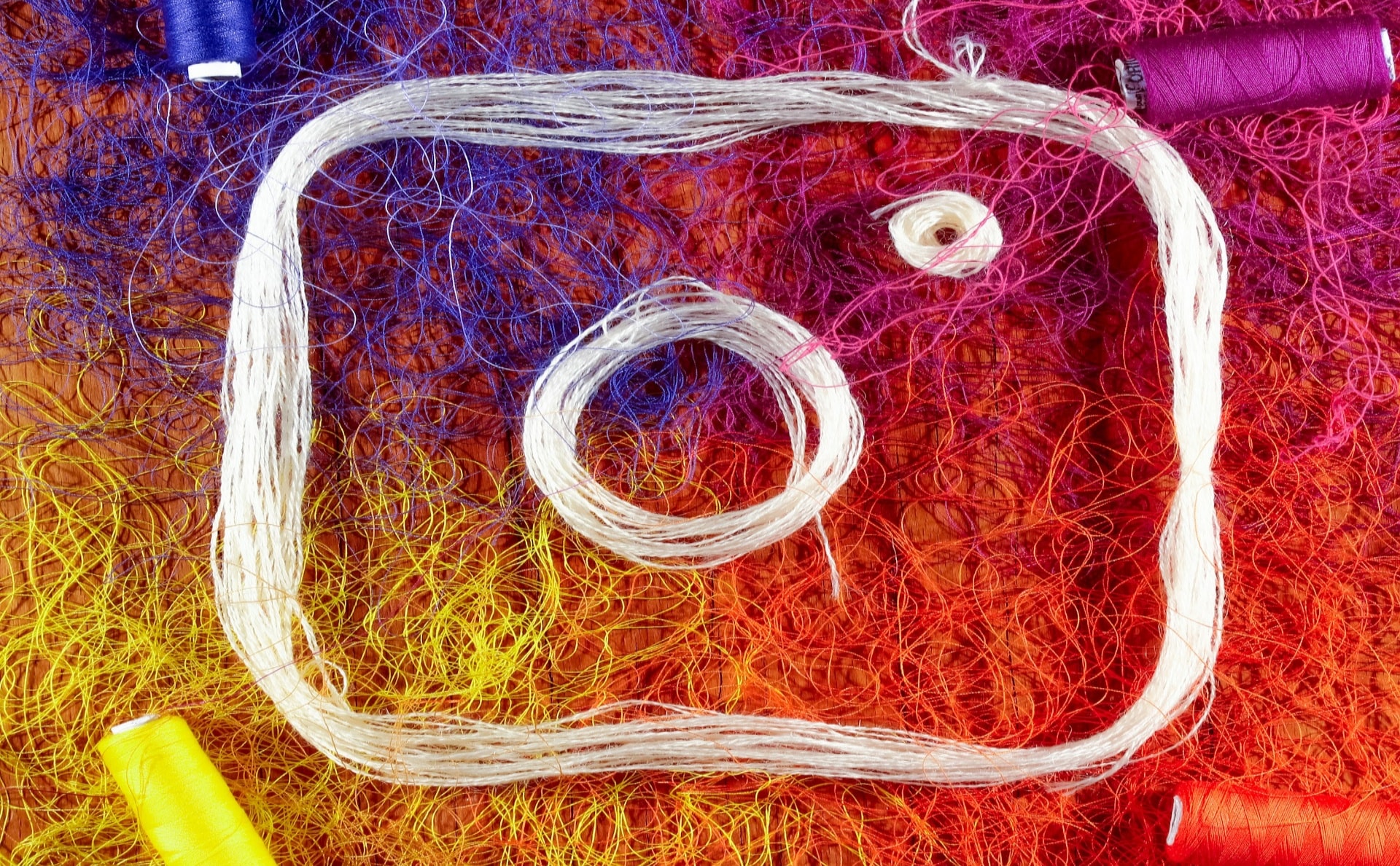 The Instagram logo formed with a mix of colored threads