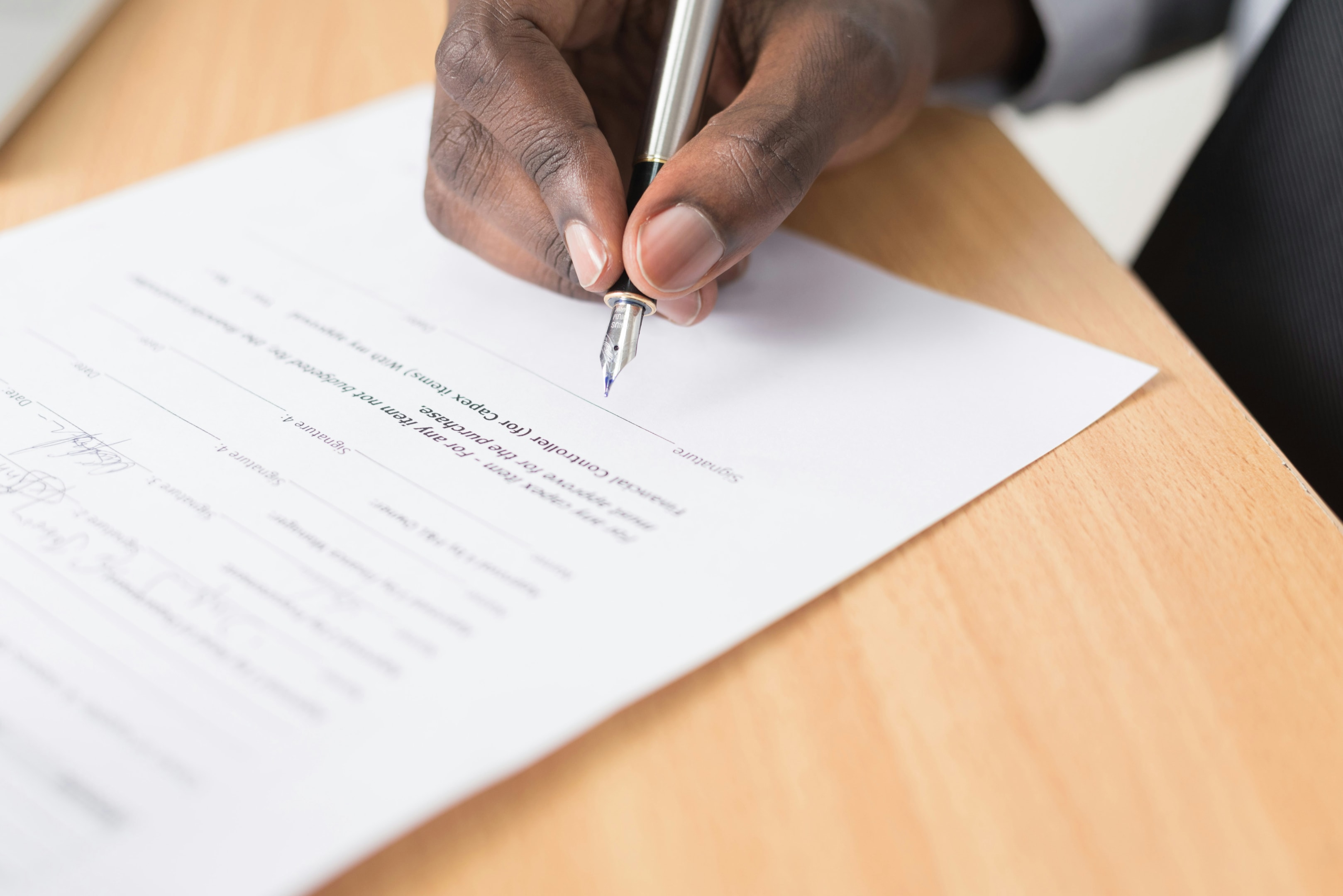Real estate investor signs financing paperwork for house flip. 