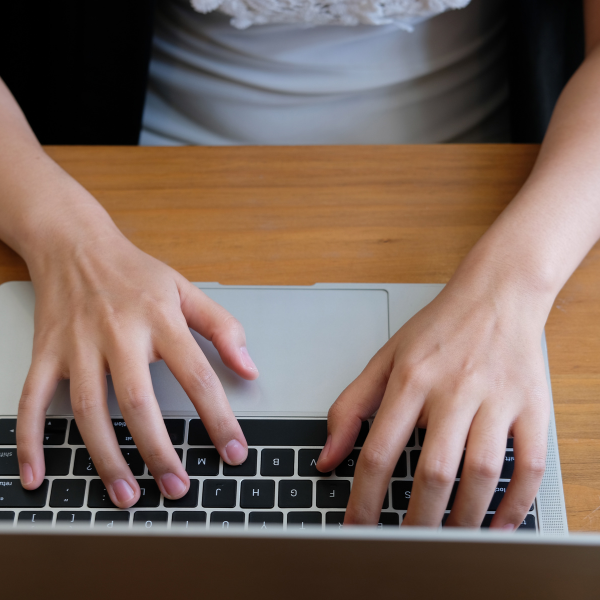 An image of a person researching metal roofing companies on a computer.