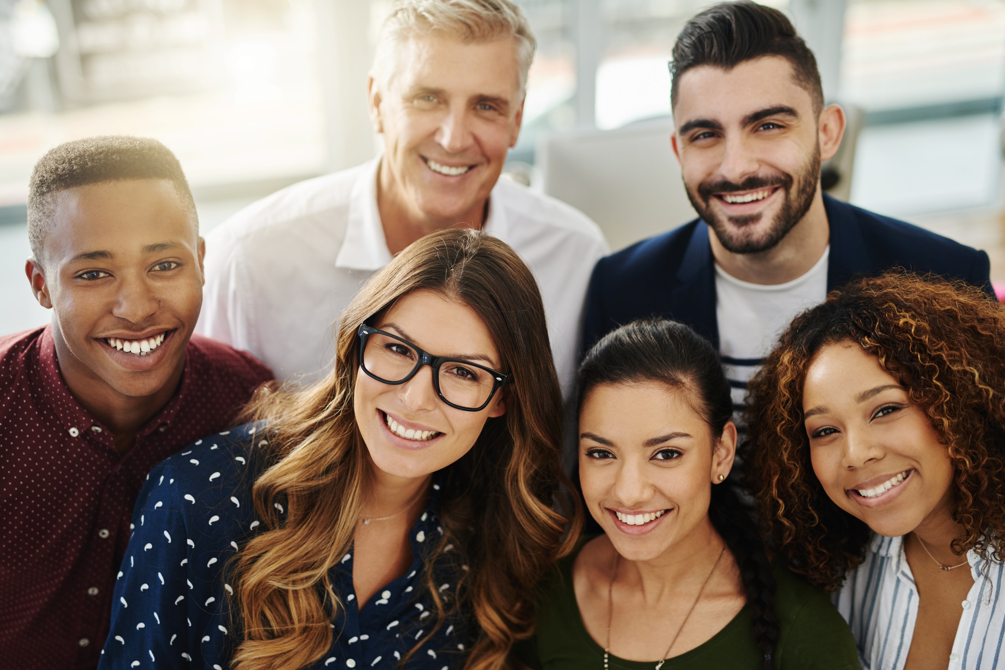 Group of adults smiling after fixing their obstructive sleep apnea