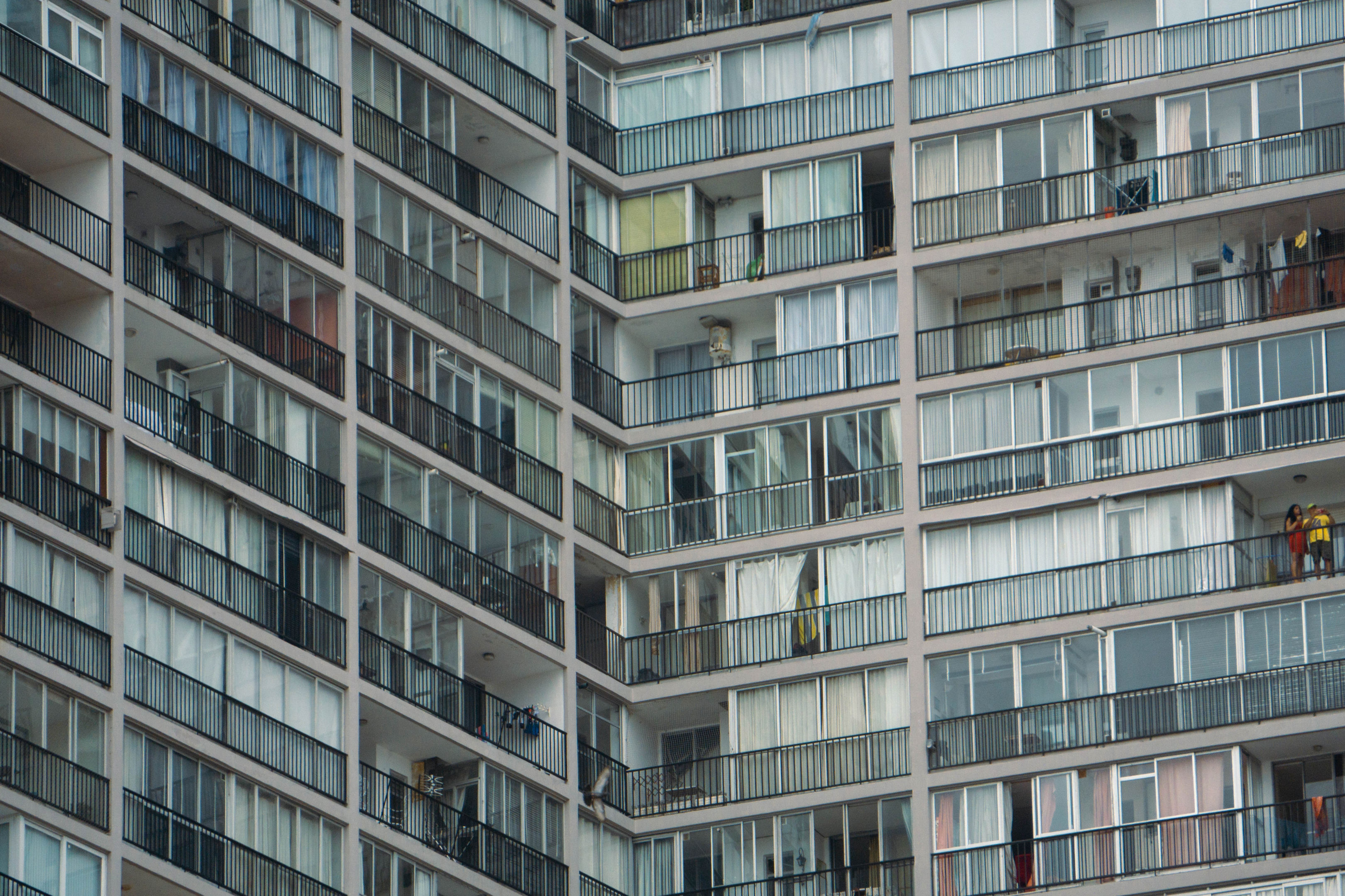 View of a modern apartment building with ceiling-to-floor windows