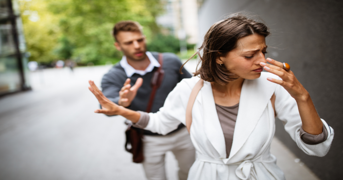 A photograph of a couple standing in Central Park with tense expressions on their faces, possibly in the midst of an argument or disagreement. The image conveys the idea of a couple experiencing conflicts in their relationship, even in public spaces like Central Park. It suggests that seeking the services of a certified Gottman Method Couples Therapist in New York City can provide the couple with the tools and techniques needed to improve their communication, build emotional connection, and reduce conflict in their relationship, regardless of the location or situation.