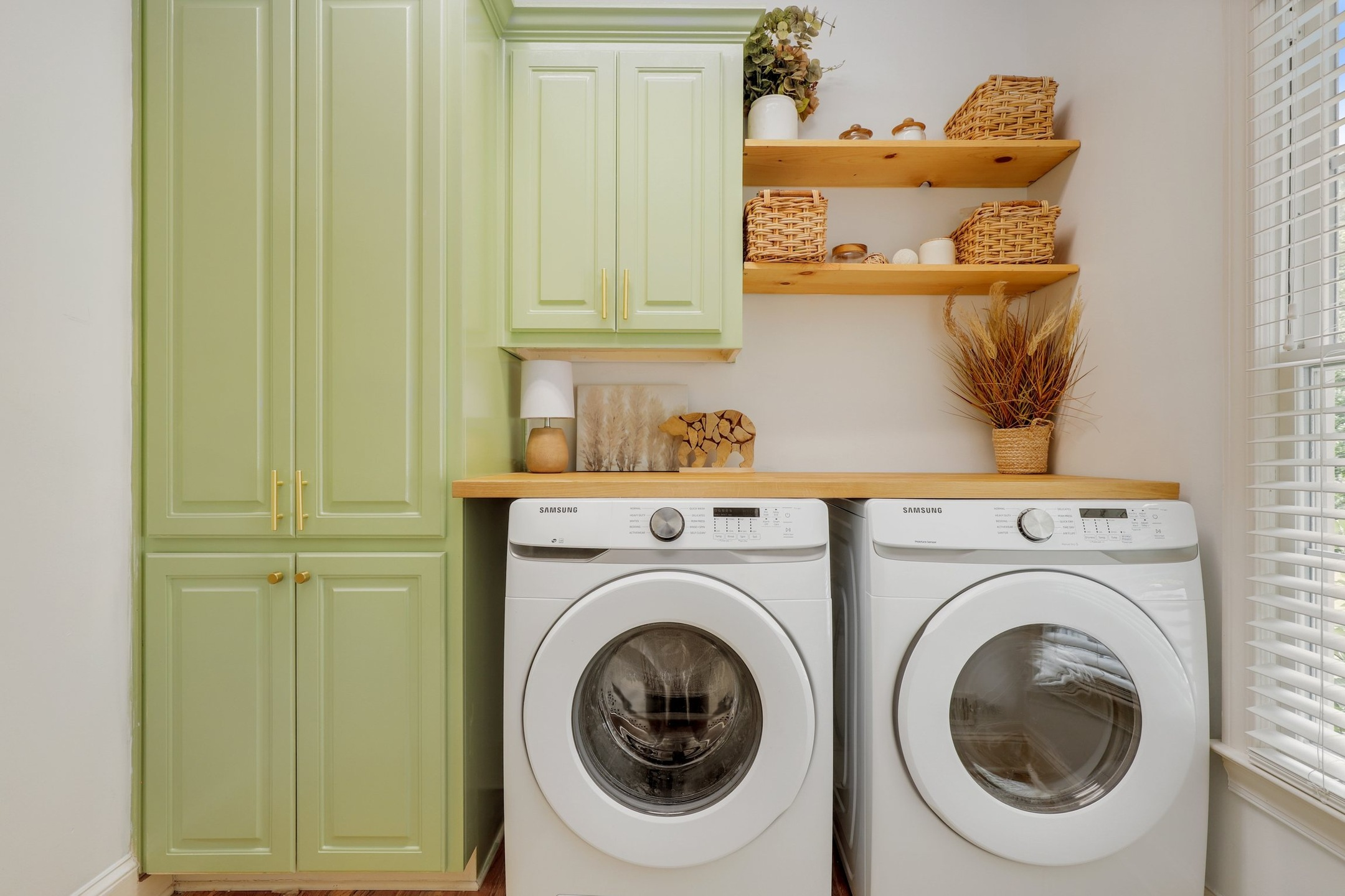 A washer and dryer combo in a dedicated laundry room of an apartment