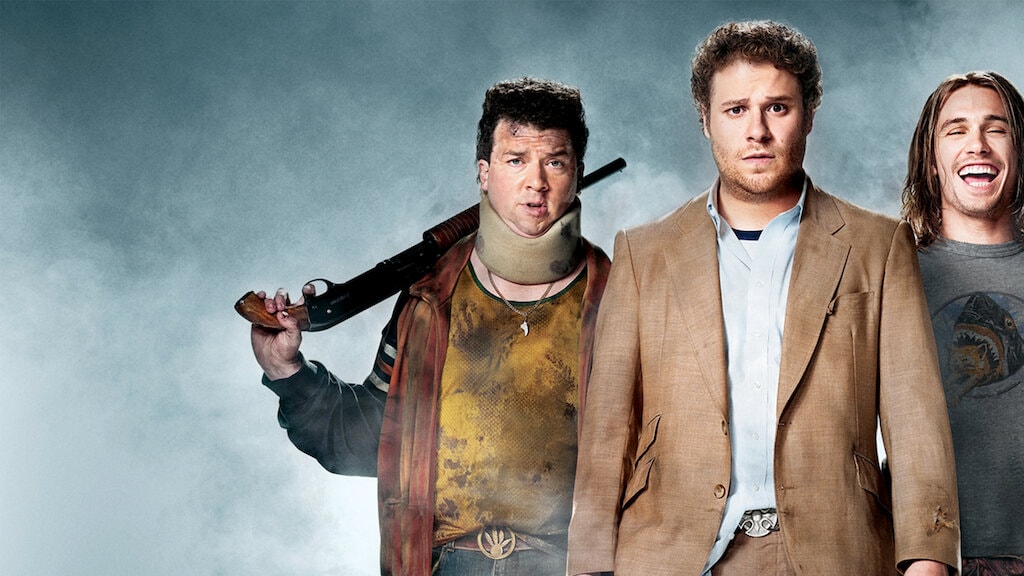 Pineapple Express movie poster featuring Seth Rogen and James Franco holding weapons with a hazy background.