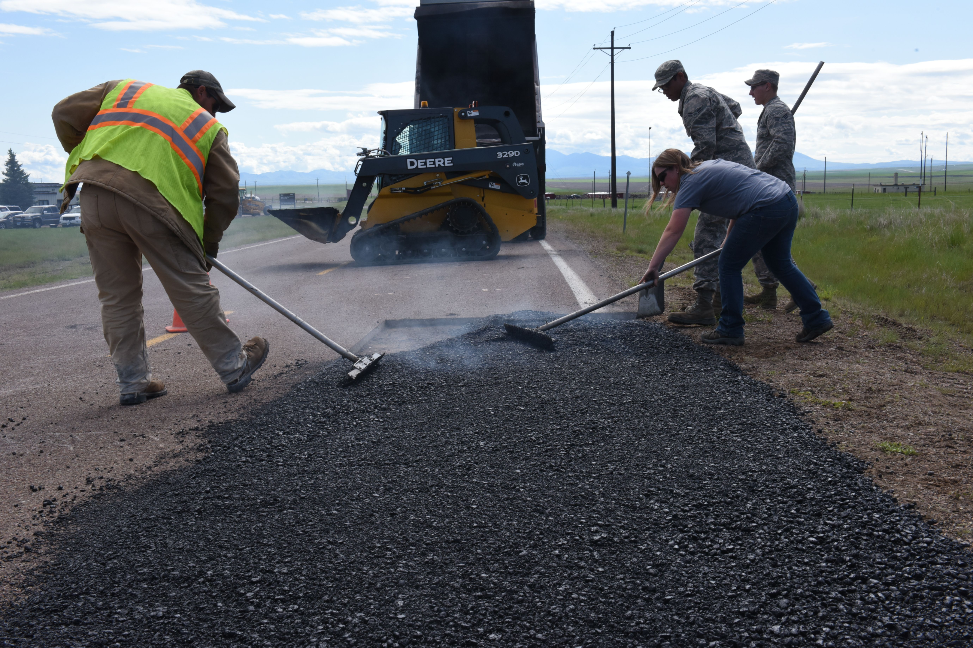 Hot liquid asphalt being mixed with heated aggregate materials