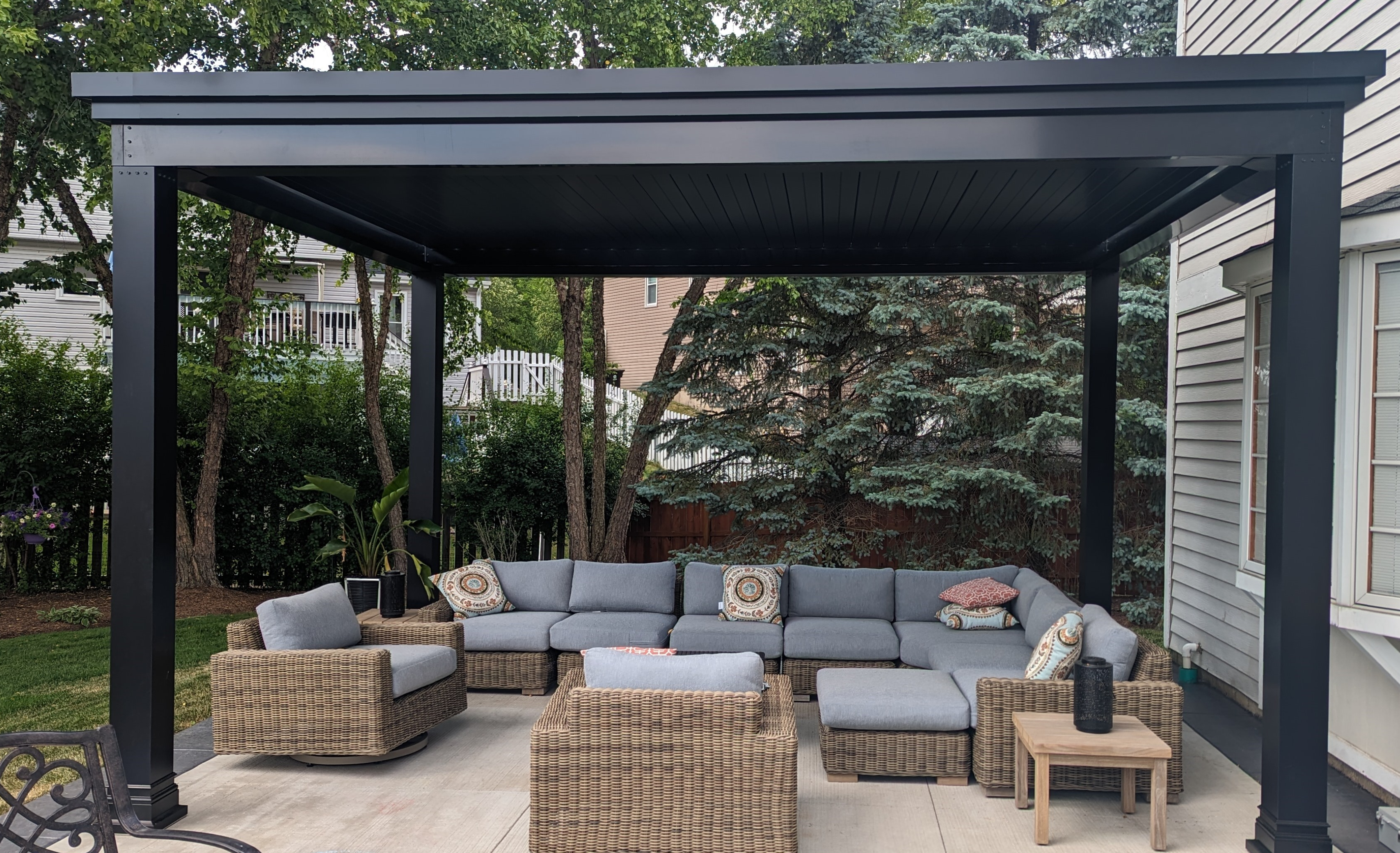 Outdoor living room with luxury pergola, outdoor seating installed over a patio.