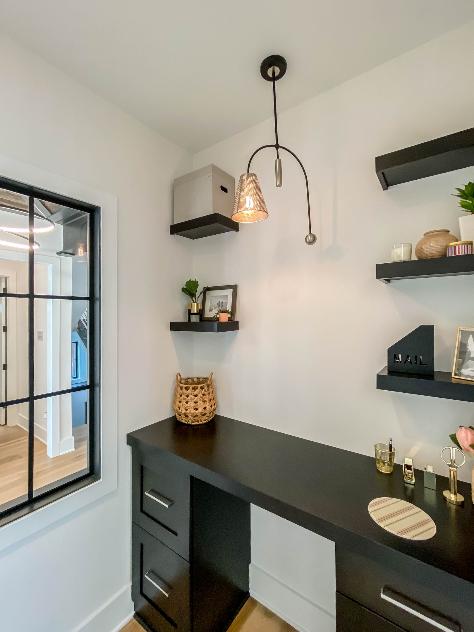 Modern home office with a Filter 1-Light Pendant, featuring a unique industrial design over a black desk, adding focused lighting and flair