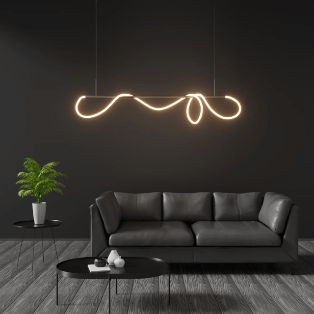 Abstract LED linear pendant light with flowing sculptural form suspended above a modern living room seating area.