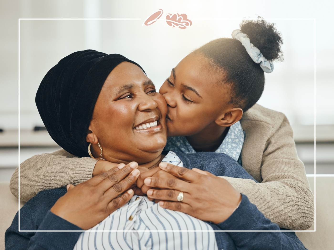 Daughter kisses her mother, sharing a loving Mother’s Day moment.