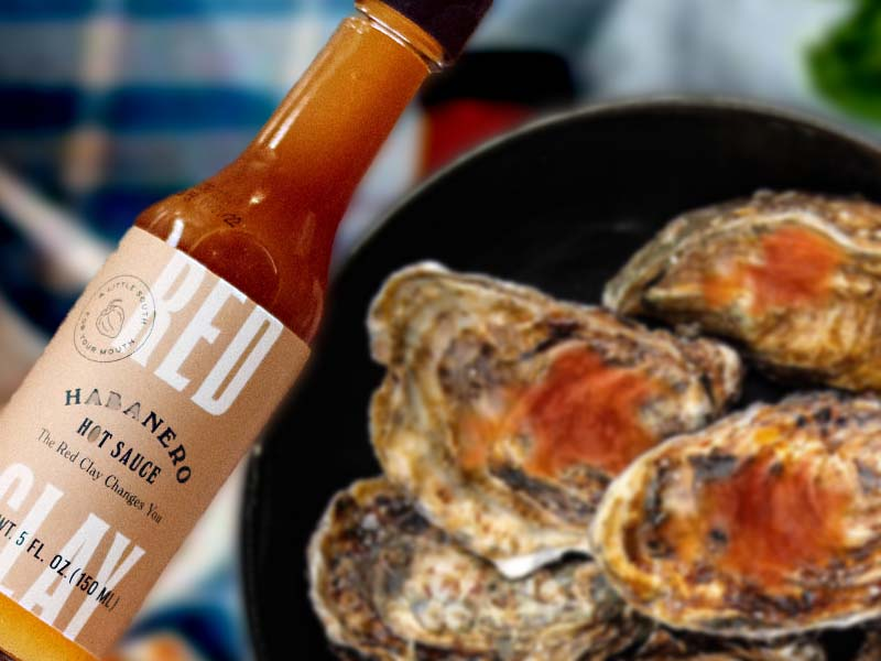 A classic grilled oyster dish prepared with Red Clay Hot Sauce.